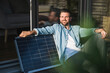 © Westend61 - Happy contemplative freelancer sitting with solar panel