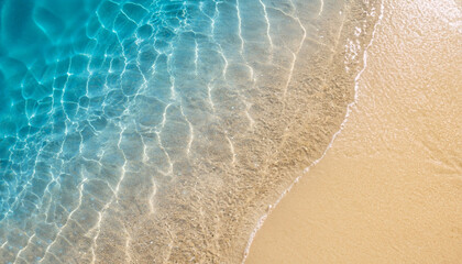 Wall Mural - abstract sand beach from above with light blue transparent water wave and sun lights, summer vacation background concept banner with copy space, natural beauty spa outdoors