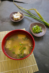 Wall Mural - miso soup or Japanese miso soup in bowl on the table. Japanese cuisine in the form of soup with dashi ingredients, tofu, seafood, vegetables, and topped with miso to taste