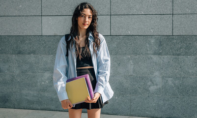 Wall Mural - teenage student with backpack and books at university