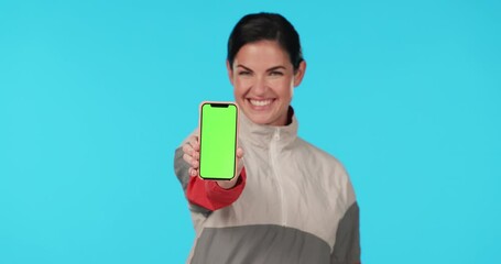 Canvas Print - Woman, phone and smile by green screen in studio with face, mockup or excited for promo by blue background. Lady, model and show smartphone with tracksuit for sport app, logo and branding in portrait