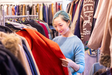 Stylish Asian Woman Is Choosing Second Hand Sweater From The Clothing Shop For Winter Season Fashion To Keep Warm At The New Year And Christmas Holiday