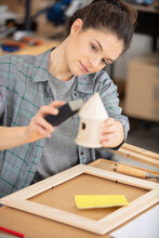 Attractive Female Carpenter Using Some Tools In Her Workshop