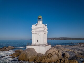 Sticker - Shelley Point lighthouse on a rocky beach on a sunny day in South Africa