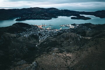 Poster - Aerial view of a small harbor surrounded by mountains