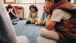 © Jacob Lund - Group of children sitting in a circle in a classroom
