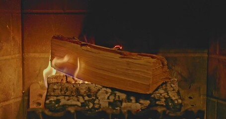 Canvas Print - Closeup video of burning firewood in a bright fire illuminating and warming the room