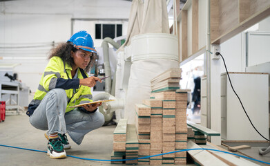 Wall Mural - Portrait, female multiracial carpenter working in carpenter's shop small business. Afro hair woman in goggles works with plank in carpentry workshop. Empowerment joiner women in woodworking industry.