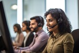 Fototapeta Sport - Portrait of female call center worker accompanied by his team. Smiling customer support operator at work. Diverse group of people.