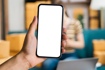 Man holding smartphone with blank screen, close-up of hands. Space for text.