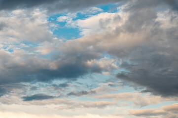 Wall Mural - Cumulus clouds and gaps of clear blue sky.