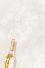 Top View Sparkling White Wine, Bottle Of Champagne With Bokeh On Beige Background, Copyspace. Festive Alcohol Drink, Wedding Party Drink Concept, Beige Pastel Monochrome Card, Minimal Invitation