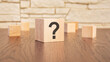 © Maks_Lab - wooden blocks with question sign on wooden table, close up. space for text
