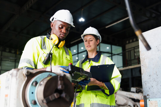 team of manager architectural engineer checks and control automation robot arms machine in an intell