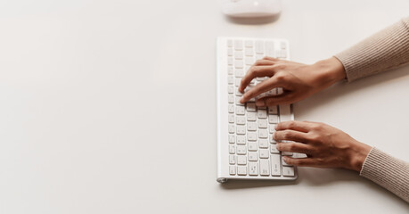 Close-up portrait typing keyboard on laptop computer. Working online on white table at office. Facebook chat. Website meeting. Blogger. Journalist writing articles. online job ideas