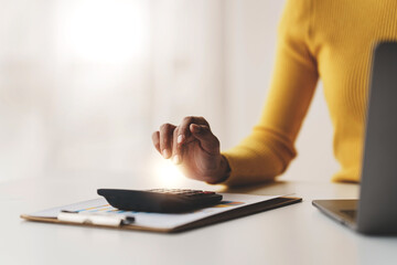 Accountant working on desk using calculator to calculate financial report in office business accounting finance concept