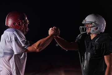 Two american football players face to face in silhouette shadow on white background