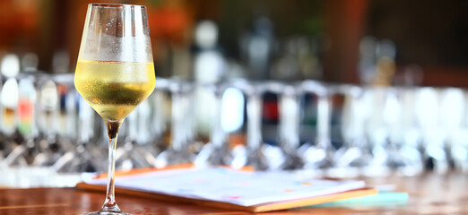 a glass of white wine in a restaurant, alcohol luxury background