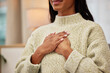 © Malik/peopleimages.com - Closeup of a woman holding her chest while breathing for calm, peace and zen mindset for meditation. Breathe, relax and zoom of a female person hands on her heart for grateful gesture in living room.