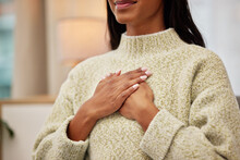 Closeup Of A Woman Holding Her Chest While Breathing For Calm, Peace And Zen Mindset For Meditation. Breathe, Relax And Zoom Of A Female Person Hands On Her Heart For Grateful Gesture In Living Room.