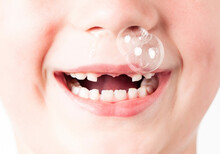 Children's Cold. Children's Runny Nose Known As Baby Snot. Funny Big Bubble Of Snot From Child Nose.