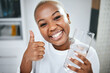 Thumbs up, yes and portrait of black woman with water for diet success or detox start. Happy, healthy and an African girl with an emoji hand for liquid goal or care with a glass in the morning