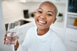 © Lategan/peopleimages.com - Portrait, glass and black woman drinking water, smile and health with joy, nutrition and laughing. Face, female person or happy girl in her kitchen, liquid and home with happiness, wellness and detox