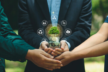 Group of businesses holding glass jars with a tree growing from money investment and financial metaphor. Saving money and finances and Green business growth, Eco business investment.carbon credit.Esg