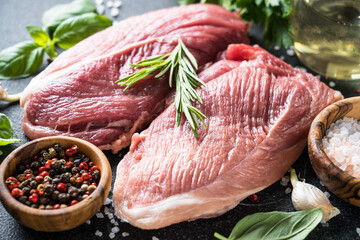 Wall Mural - Raw meat steaks with spices, herbs and oil.