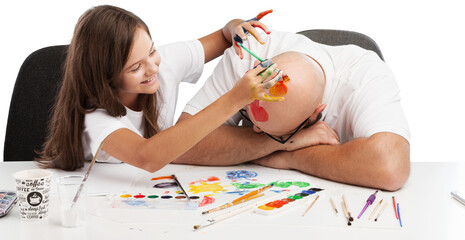 Wall Mural - Painting concept. Schoolgirl painting with father during therapy at home with his tutor with learning and having fun together.