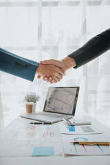 Businessmen shaking hands in office after finishing meeting team work