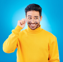 Leinwandbilder - Thinking, glasses and Asian man with ideas, solution and happiness against a blue studio background. Male person, option and model with eyewear, opportunity or choice with a smile and problem solving