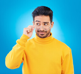 Leinwandbilder - Thinking, glasses and Asian man with ideas, decision and emoji against a blue studio background. Male person, model and guy with eyewear, opportunity or choice with solution, focus or problem solving