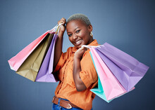 Happy, Portrait And Woman With Shopping Bags In Studio After Sale, Promotion Or Discount. Smile, Excited And Luxury African Female Customer Posing After Buying Products Isolated By A Gray Background.