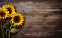Three Beautiful Sunflowers On A Wooden Background With Copy Space