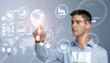 © Paulista - Man touchs a HUD virtual screen with financial anlytics graphs. Digital data management system concept