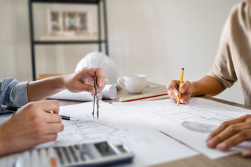 Leinwandbilder - Architects interior designer hands working with Blue prints and documents for a home renovation for house design