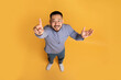 © Prostock-studio - Top view of creative young asian guy in casual outfit pointing finger up