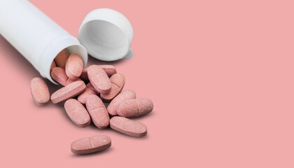 Wall Mural - Pink medical pill on desk background.