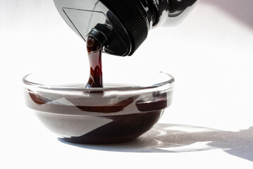 Wall Mural - Pouring Date Syrup in a Bowl