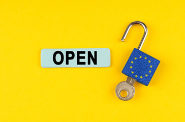 Poster - On the yellow surface is an open lock with a key and a sticker with the inscription - open