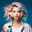  Attractive girl with colorful hair listening to music with big headphones. Portrait of a beautiful young woman with headphones listening to music. Fashion stylish portrait of a white girl on a blue.