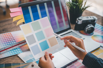 Fototapete - Graphic designer architects who work with laptops and color comparison tables for design work..