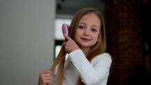 Camera Pov Portrait Of Adorable Pretty Little Girl Brushing Her Long Silky Hair And Smiling, Slow Motion