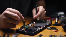 A Technician Repairing A Broken Smartphone