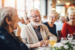 © MVProductions - Joyful senior citizens enjoying companionship at a social club, having fun and smiling, Generative AI
