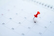 Red pin on the 15th day on the calendar. Business planning concept.