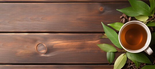 Wall Mural - Cup of freshly brewed tea with bay leaves on wooden table, flat lay. Space for text