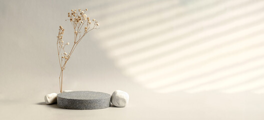 Poster - Minimal stone stage product display with sunlight from window and dry flower on cream color background