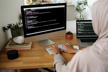 Aufkleber - Hands of young Muslim female IT engineer typing on computer keyboard while sitting by workplace in front of screen and decoding data